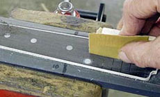 Photo: sanding the fingerboard