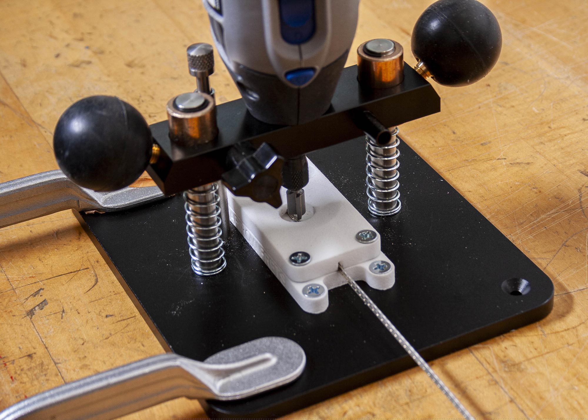 Lower the unit so the bit's cutter head blades just touch the tang.