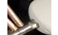 Solder gun and vise close-up