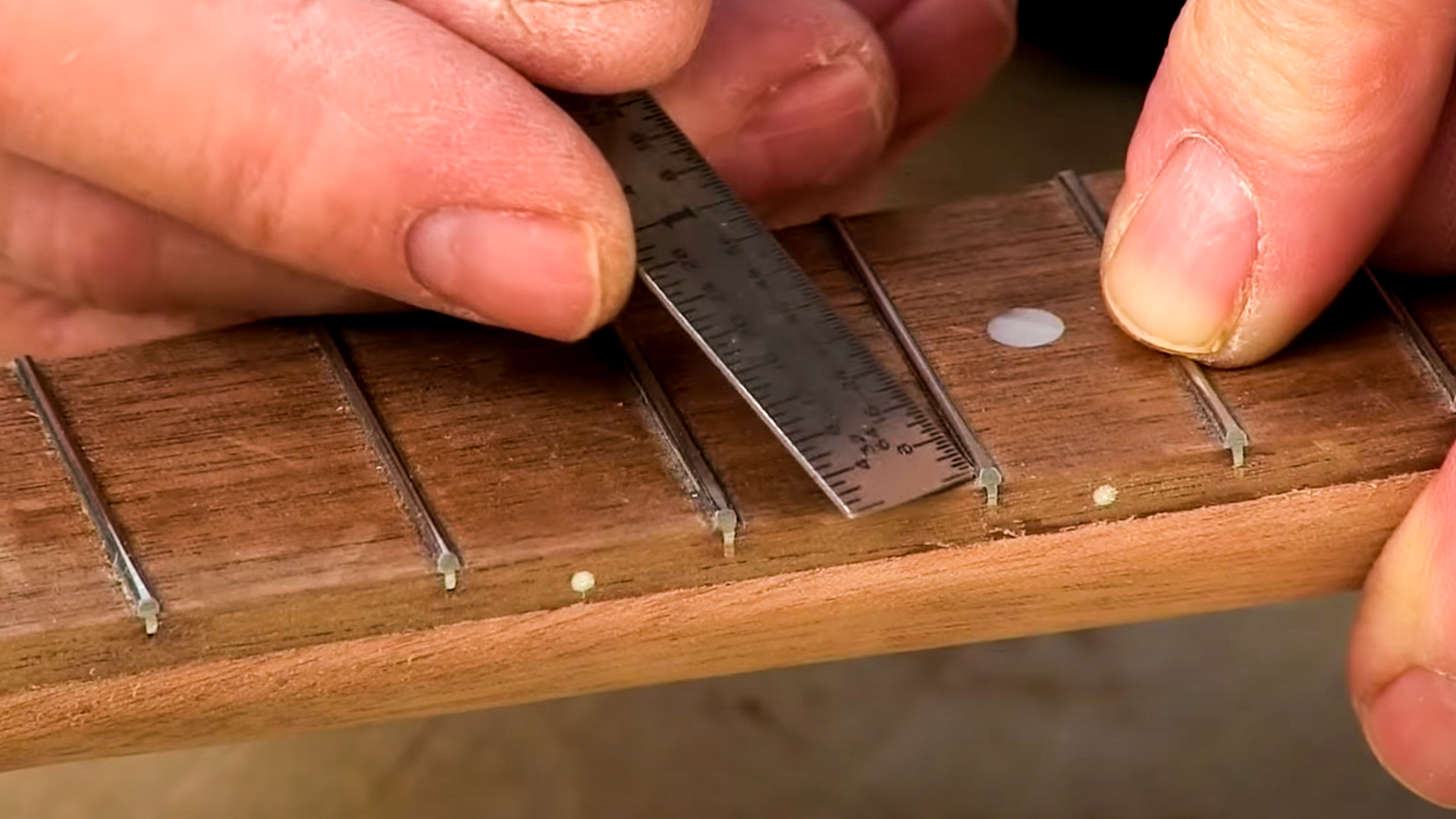 Ruler removing burr from sides of frets